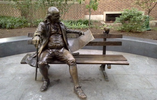 Bronze statue of Benjamin Franklin reading the Pennsylvania Gazette. Known as Ben on the Bench by University of Pennsylvania students.